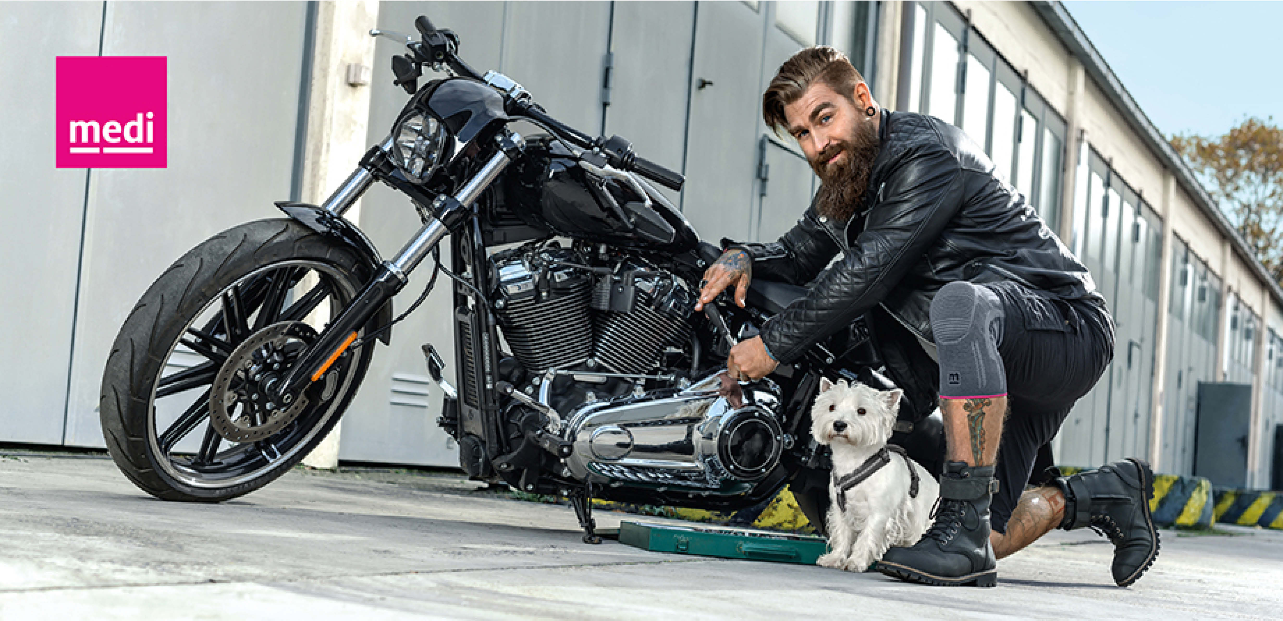 kuul fyr med motorsykkel og hund og støttebandsje på kne